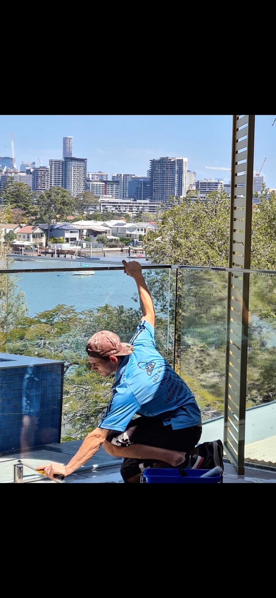 Detailing glass balustrades with the Brisbane skyline behind